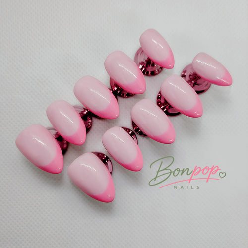 A set of artificial press-on nails with a glossy pink ombre gradient, transitioning from light pink to vibrant hot pink, displayed on a textured white background with a 'Bonpop Nails' logo watermark.
