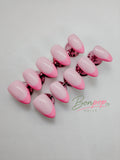 A set of artificial press-on nails with a glossy pink ombre gradient, transitioning from light pink to vibrant hot pink, displayed on a textured white background with a 'Bonpop Nails' logo watermark.